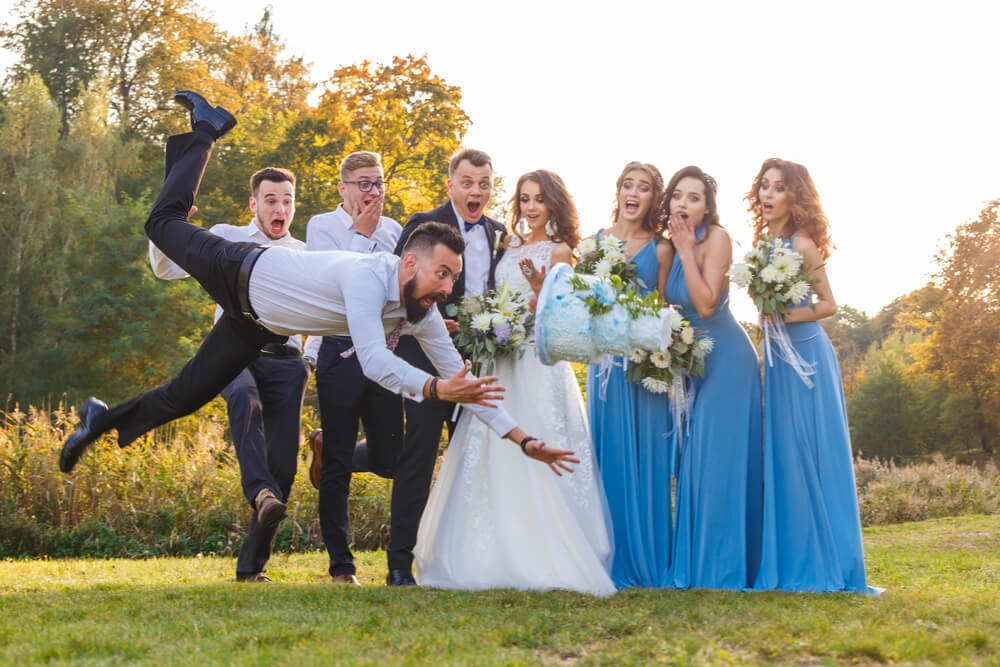 photo of a wedding party in Calgary where the groomsman drops the wedding cake